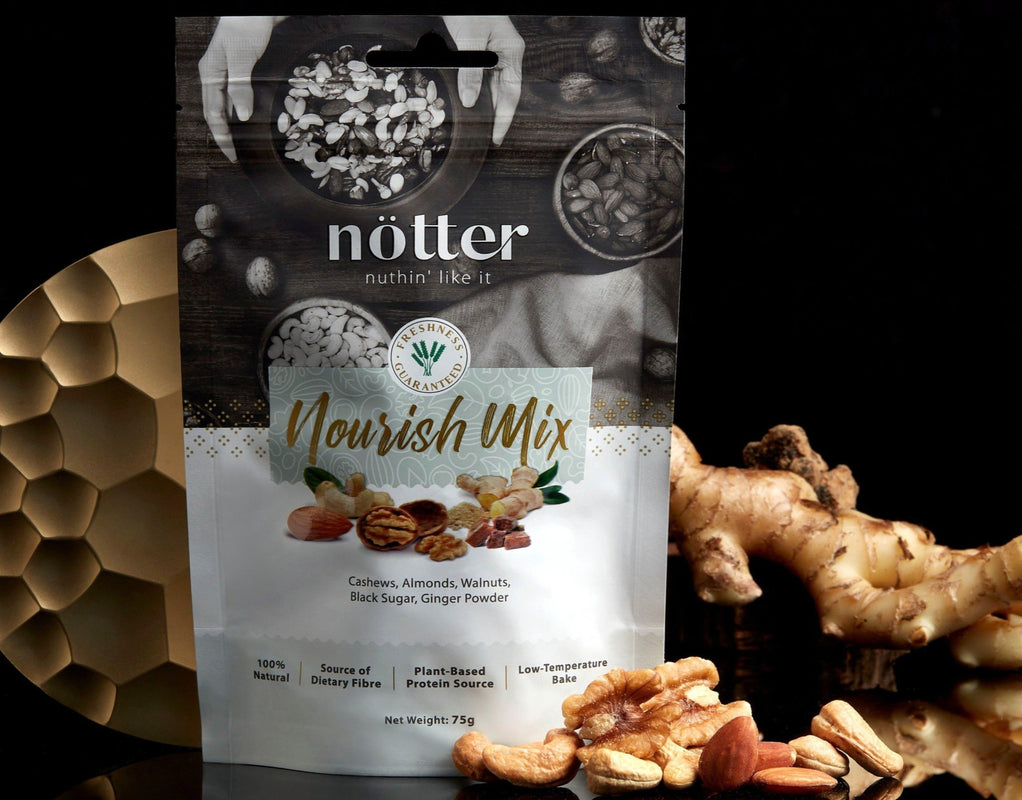A package of Nourish Mix by nötter, featuring Cashew, Almond, Walnut (infused with Ginger) and Black Sugar